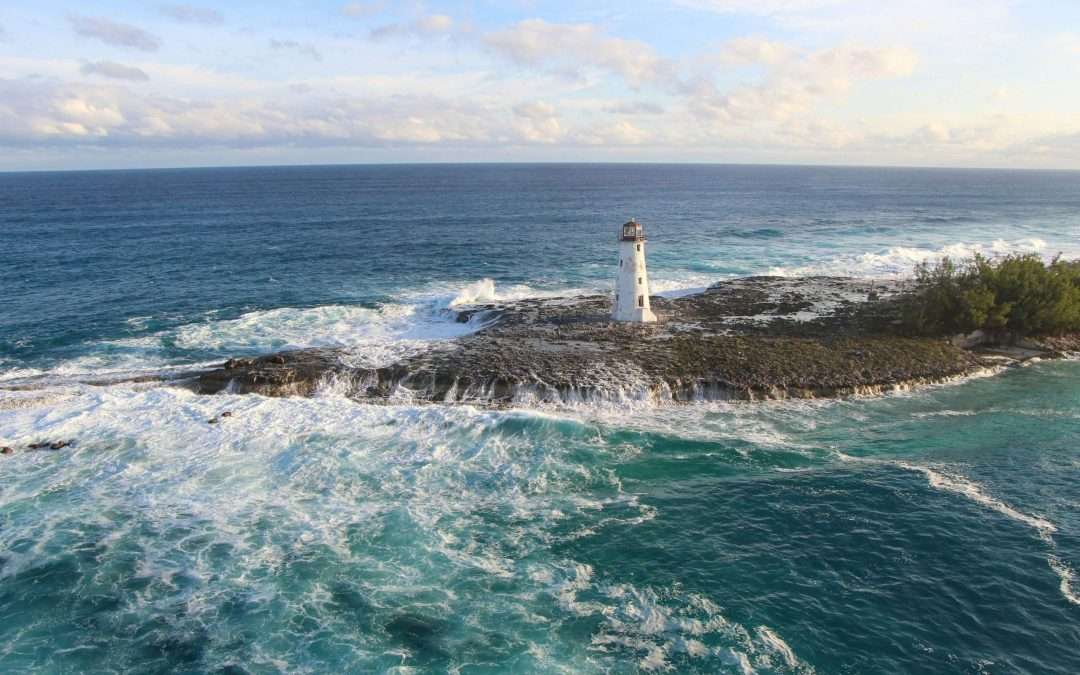Lighthouse on pier with waves