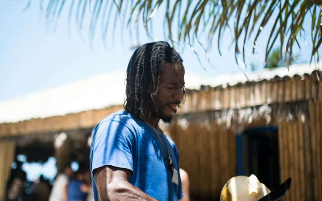 Man cutting coconut