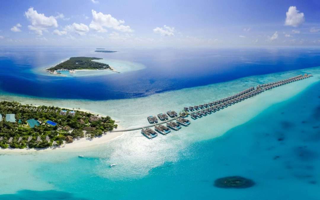 aerial view overwater bungalows tropical island