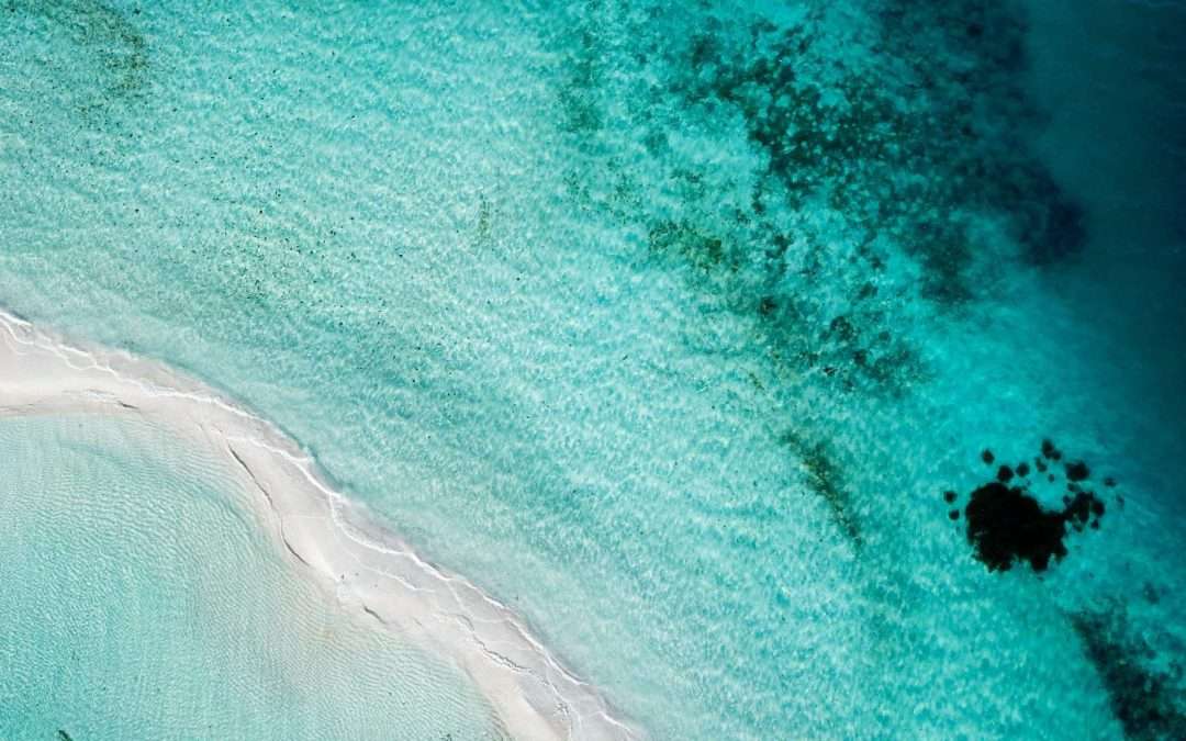 aerial view turquoise water white sand beach